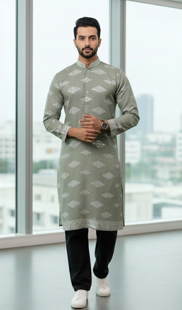 Men’s ethnic wear pista green Roman silk fabric featuring white embroidered motifs and mirror detailing for festive and wedding wear.
