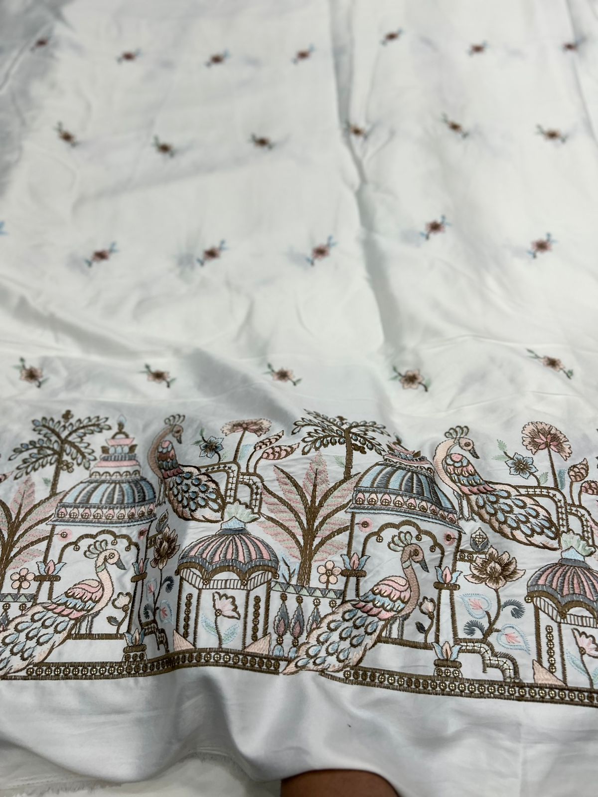 Luxury men’s kurta fabric in ivory malai satin with detailed peacock embroidery for traditional wedding and festive outfits