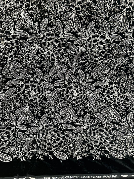 Beautiful new black velvet fabric with dense, delightful white and silver floral embroidery. It's so plush and ready for your most glamorous creations.