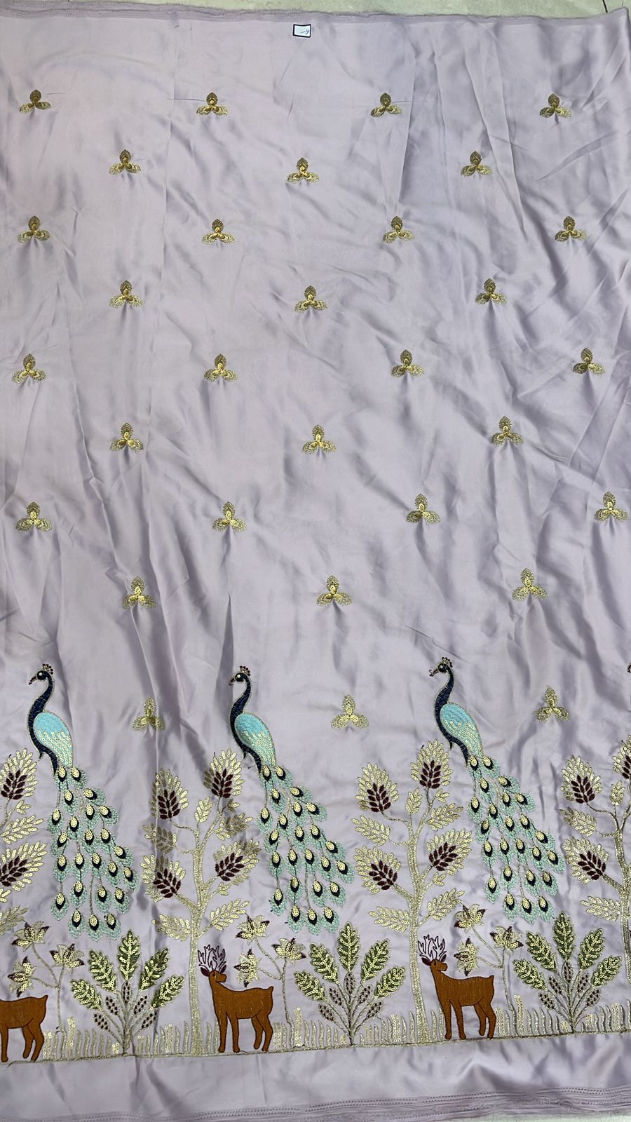 Premium lilac satin fabric with heavy peacock, tree and deer embroidery along the daman, ideal for festive men’s kurtas