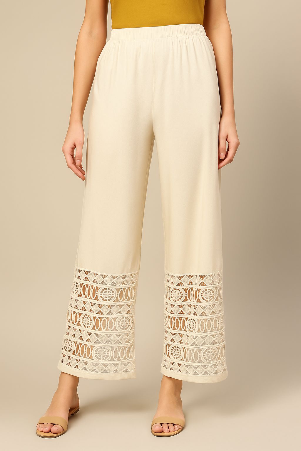 Model wearing comfortable, off-white palazzo pants featuring a wide cuff of intricate GPO Cotton Lace Fabric detailing on the hem.