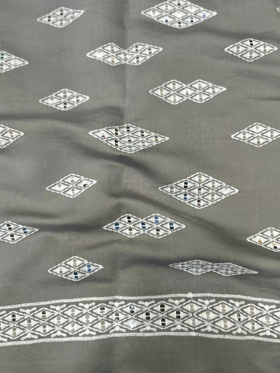 Soft skin-friendly kids grey Roman silk fabric with mirror accents and white thread embroidery for wedding outfits.