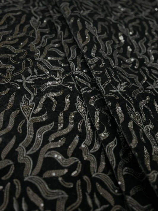 Premium black velvet fabric with intricate silver embroidery and wavy designer pattern.