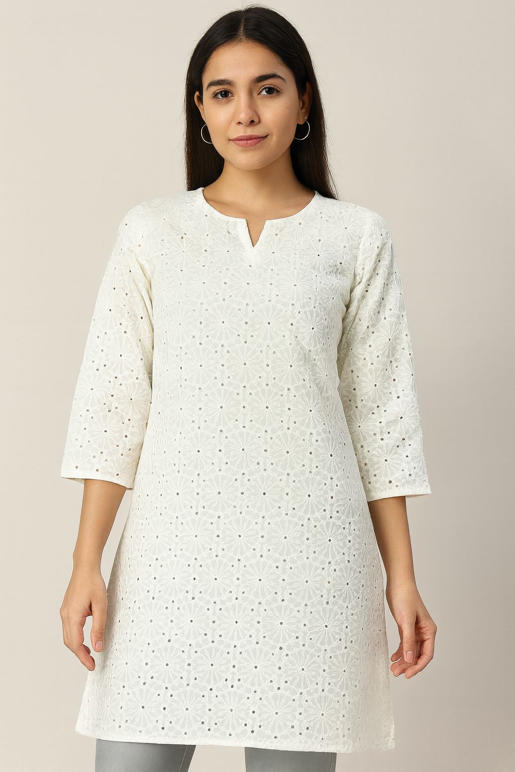 Close-up of premium white embroidered cotton fabric (Hakoba/Schiffli) for ethnic wear and breathable Indo-Western summer outfits.
