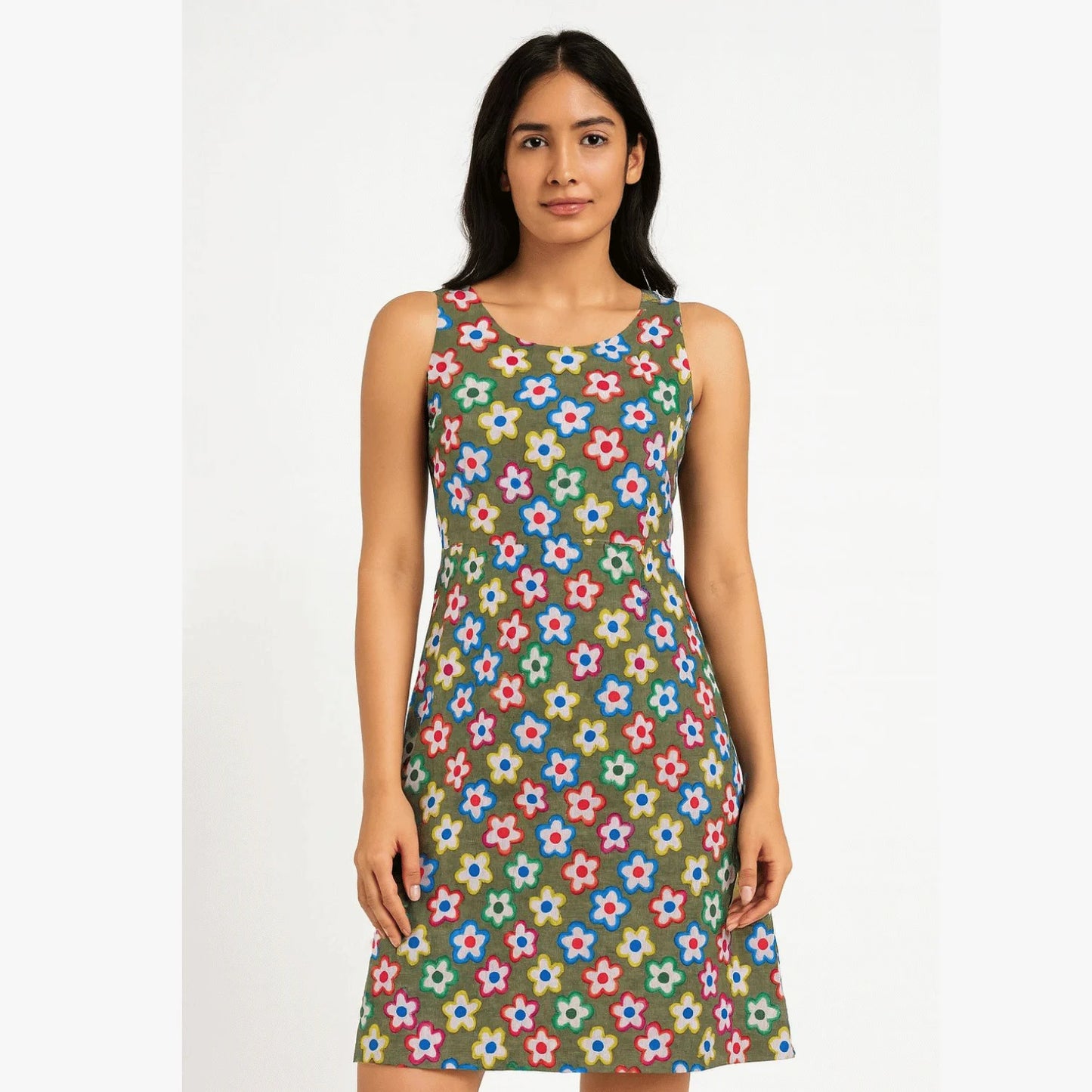 Woman wearing a sleeveless modern dress stitched from premium olive green cotton fabric with vibrant multicolor floral print. Soft, breathable lightweight fabric ideal for dresses, tops, co-ord sets, skirts and casual summer wear.