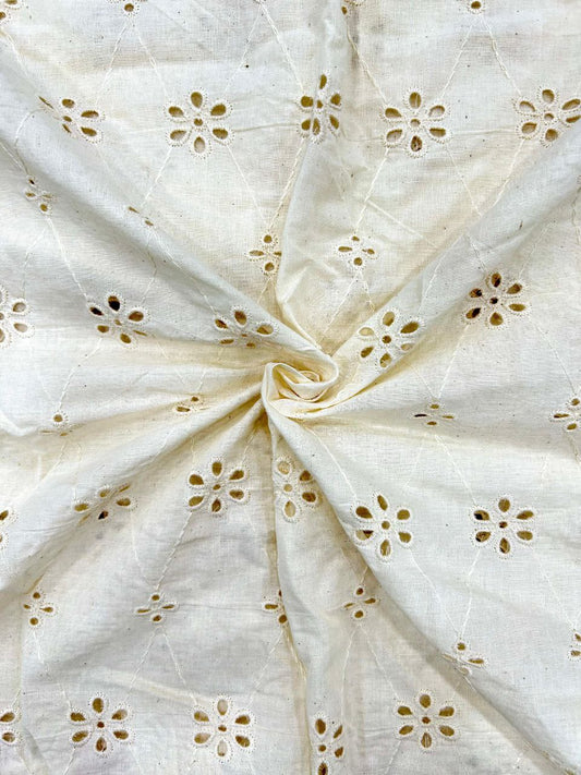Close-up of dyeable off-white cotton textile featuring intricate blooming petal motifs (Hakoba), ideal for summer dresses and custom clothing.