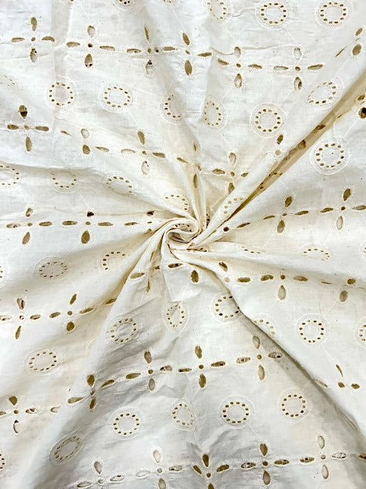 Close-up of dyeable pure cotton fabric featuring a classic embroidered dot pattern, perfect for making blouses, skirts, and dresses.