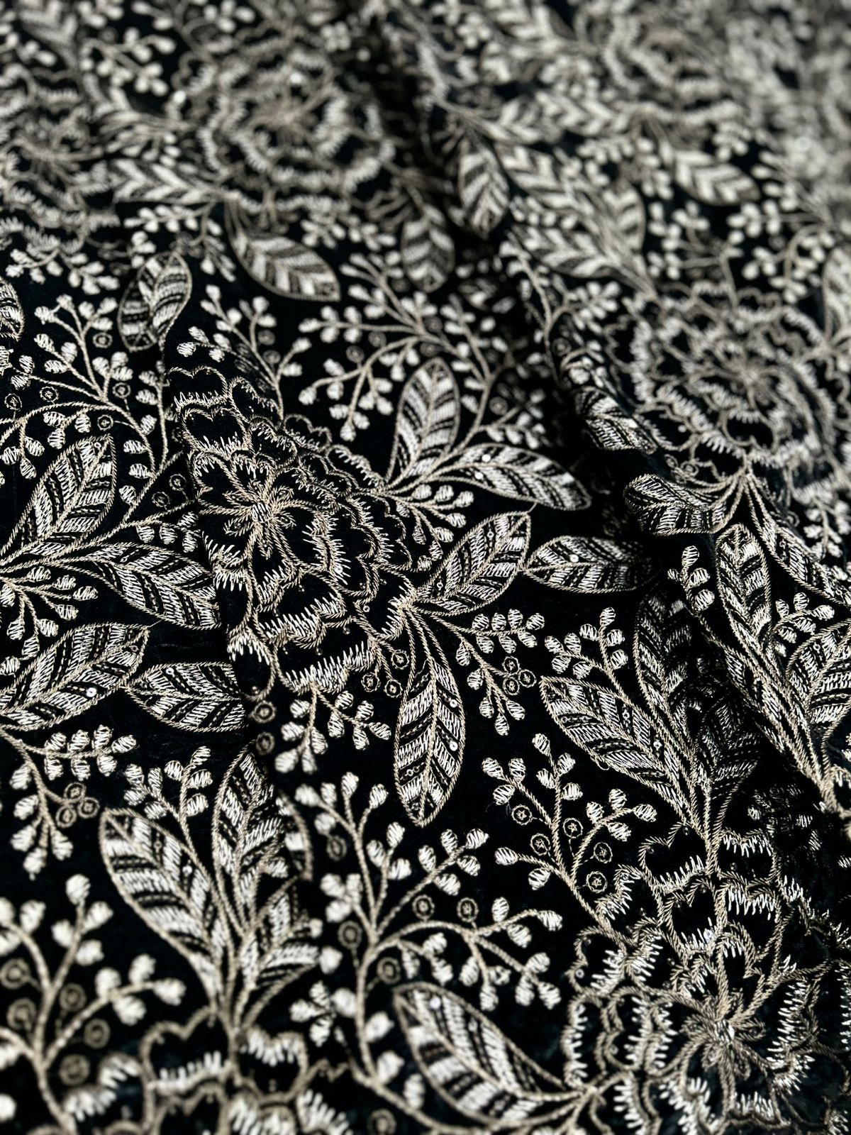 Premium black velvet fabric with intricate gold embroidery and detailed floral vine pattern.