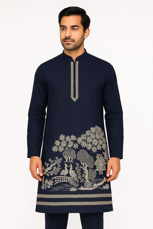 Designer navy blue fabric with highly detailed nature-themed bottom embroidery. The lower panel depicts a forest scene rendered in contrasting metallic thread.