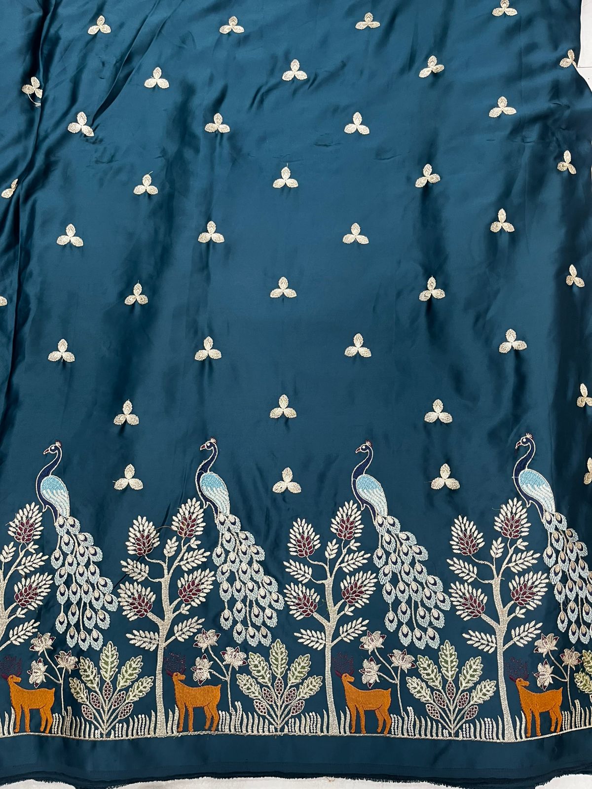 Premium emerald-teal satin kurta fabric featuring peacock daman embroidery with deer and floral detailing, ideal for wedding wear.