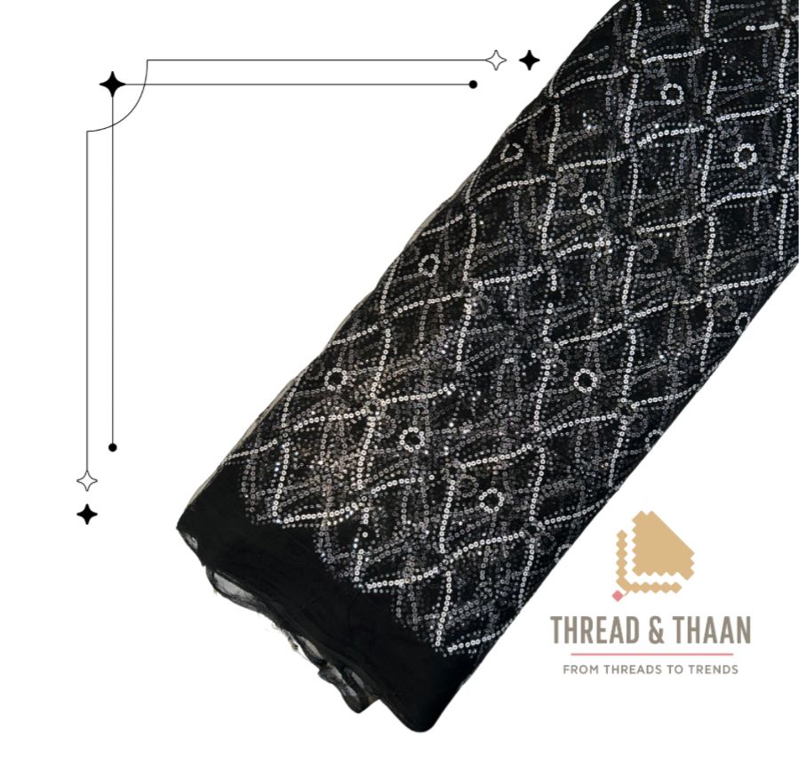 Premium black net fabric with intricate white sequin embroidery in a geometric pattern, perfect for designer sarees, lehengas, and gowns.