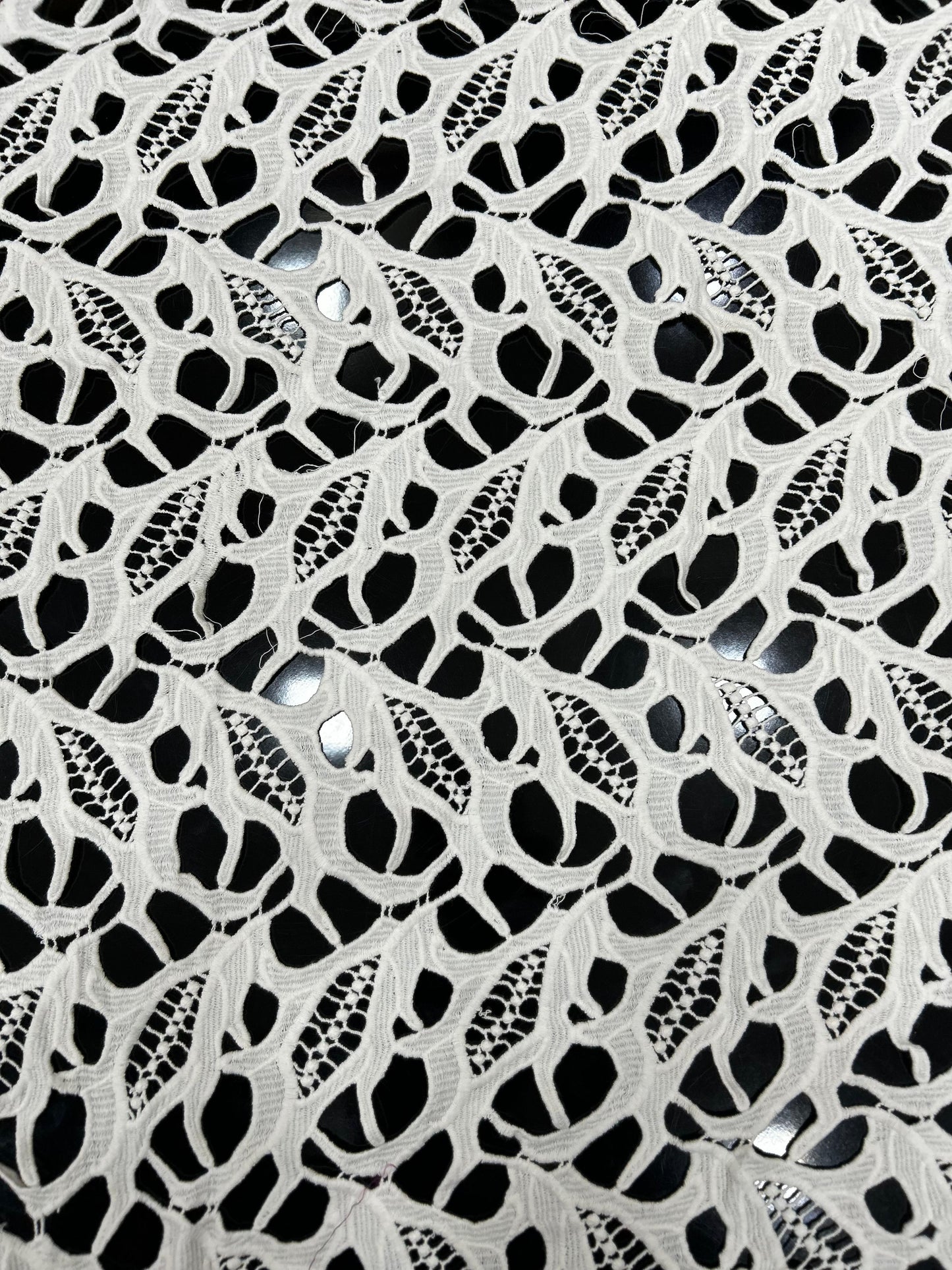 Premium white lace jacquard net fabric with leaf-pattern cutwork — ideal for tops, kurtis, overlays and designer garments.