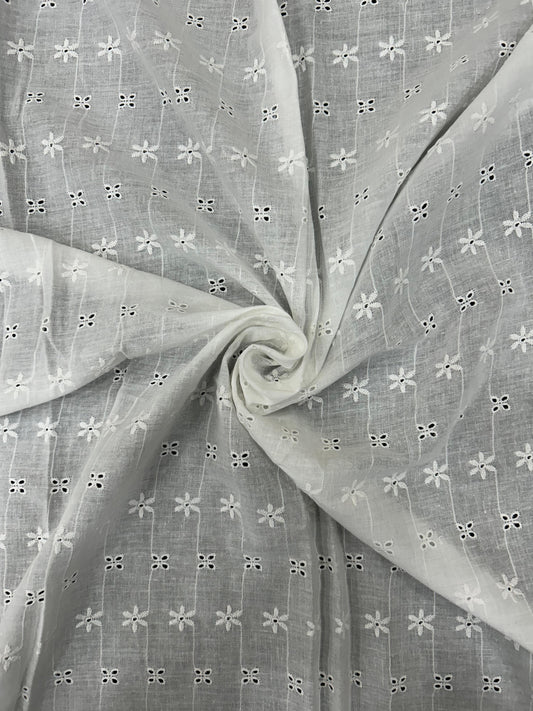 Premium White Hakoba Schiffli Cotton Fabric, soft and breathable, featuring intricate cutwork embroidery for elegant kurtis and summer outfits.
