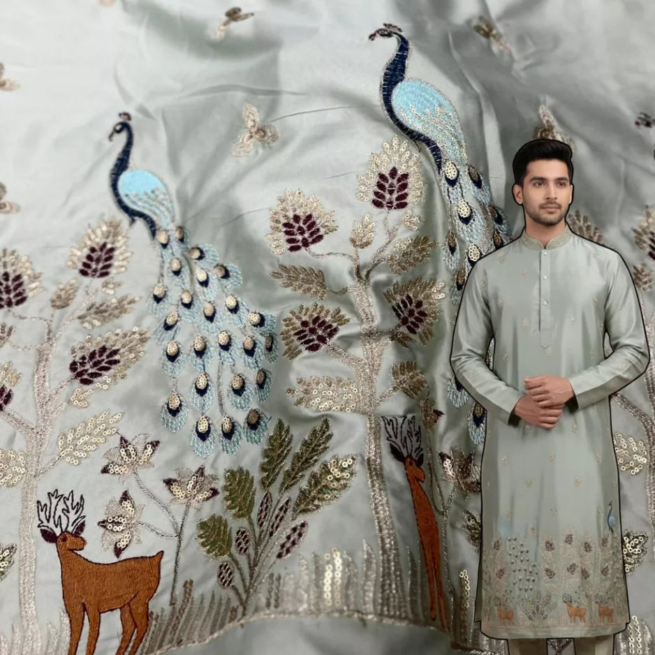 Pista green malai satin fabric featuring traditional peacock daman embroidery, ideal for men’s wedding kurtas and festive ethnic wear.