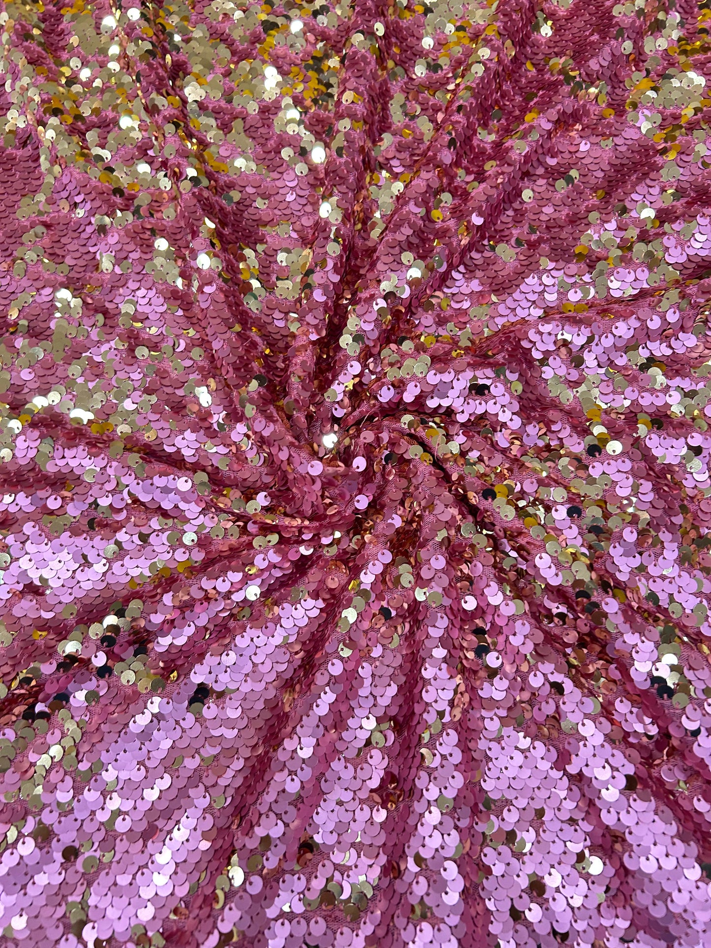 Close-up of premium dual-tone sequin fabric in pink and gold, ideal for making glamorous blouses and luxurious party wear outfits.