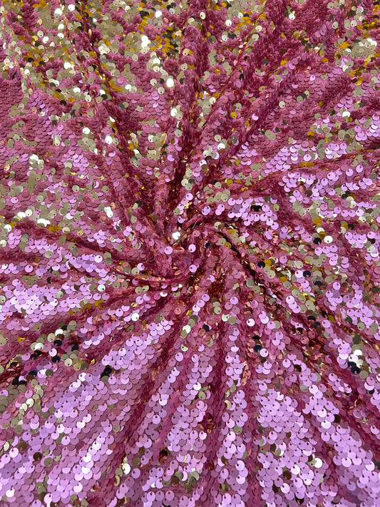 Close-up of premium dual-tone sequin fabric in pink and gold, ideal for making glamorous blouses and luxurious party wear outfits.