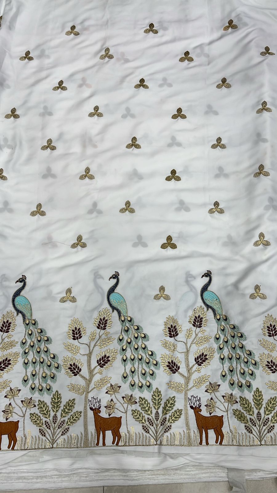 Premium ivory malai satin men’s fabric with peacock daman embroidery and intricate sequin floral detailing, ideal for kurta and sherwani.