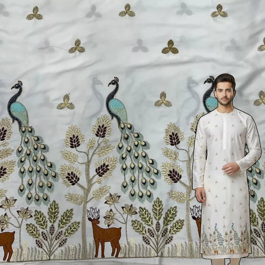 Ivory satin kurta fabric featuring heavy peacock border embroidery with sequins, trees and deer motifs for festive and wedding wear.