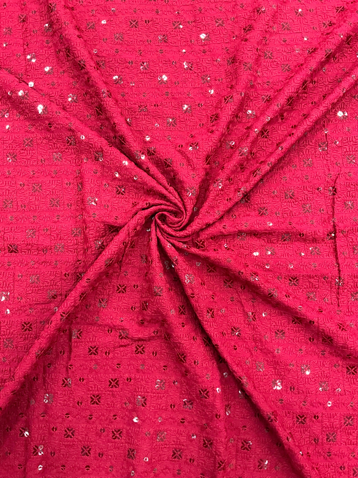 "Kids kurta outfit made from pink embroidered fabric shown beside the fabric close-up swatch."