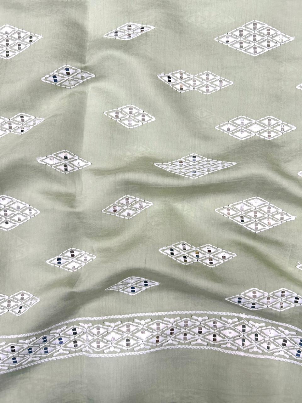 kids kurta fabric in pista green with contrast white thread embroidery and mirror work for wedding wear.