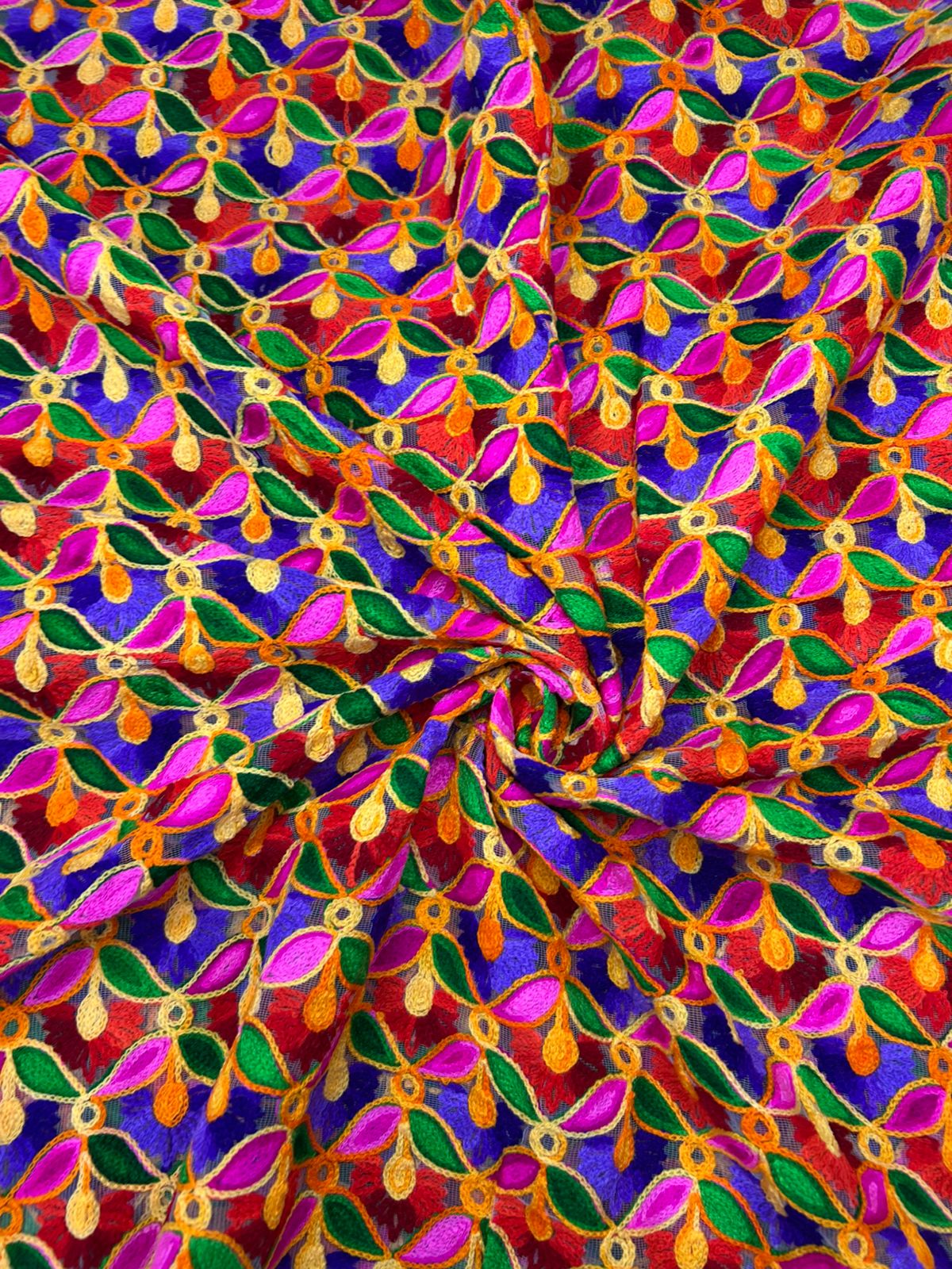 Premium festive silk brocade textile featuring colorful leaf and floral pattern.