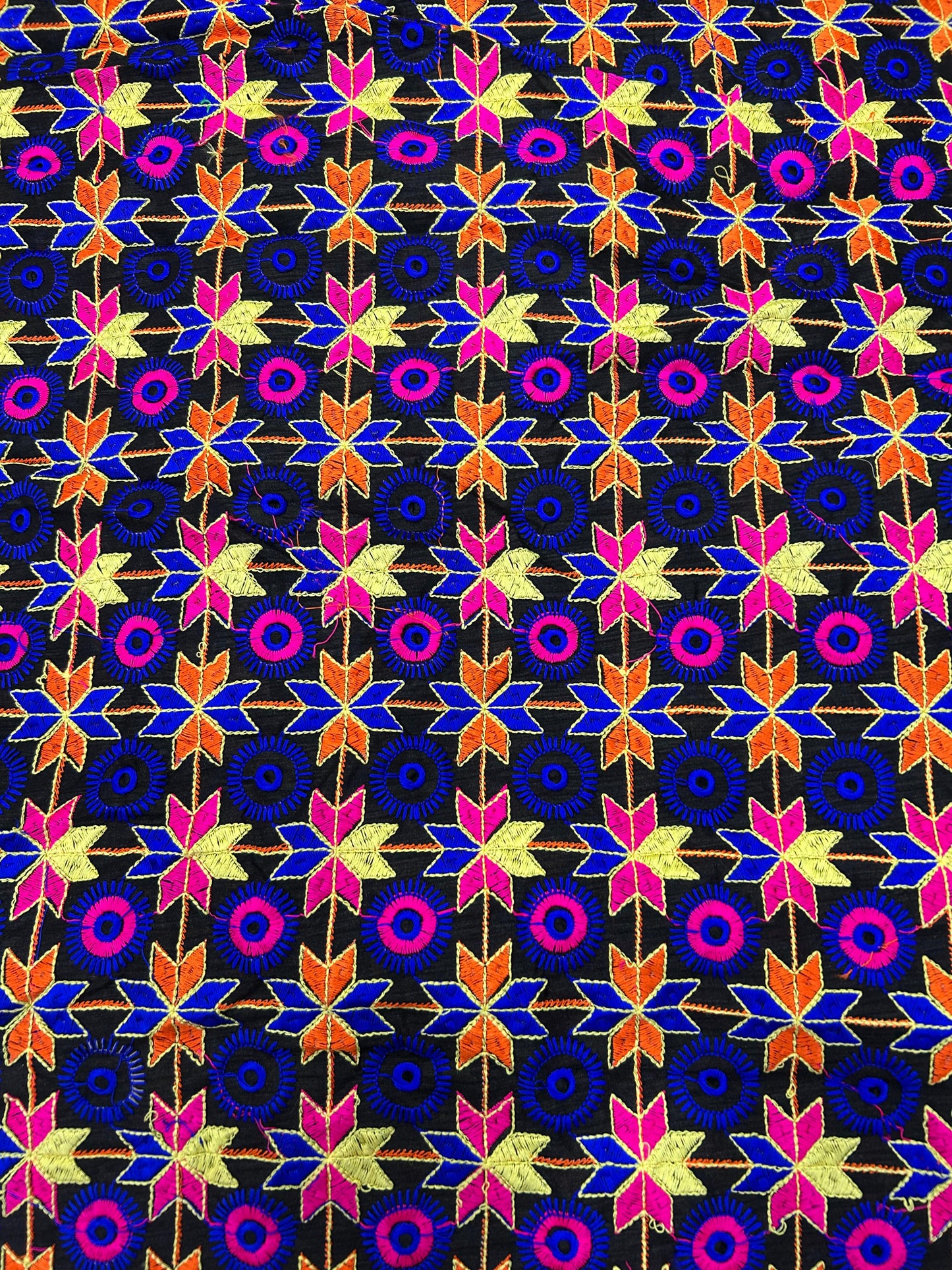 Black brocade silk fabric with multicolor geometric floral woven pattern.