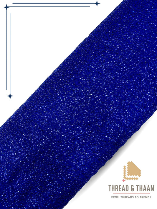Blue shimmering georgette fabric with sparkling textured pattern for fashion wear.
