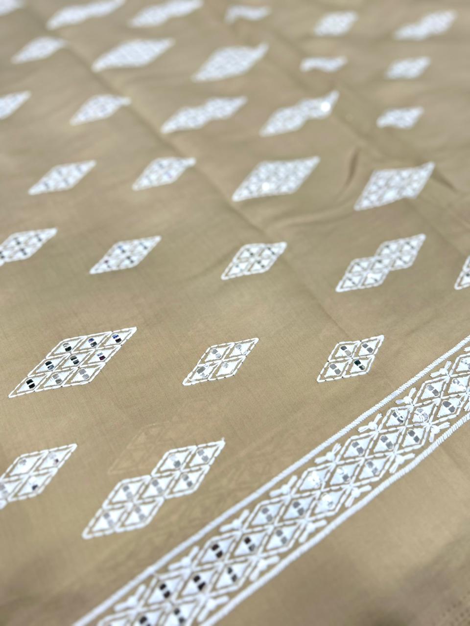 Premium beige Roman silk fabric for men with detailed mirror work and white embroidery — ideal for wedding wear.