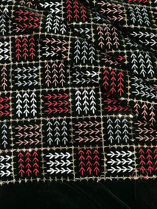 Black velvet embroidered fabric with red, white and peach geometric arrow stitch design, heavy luxury velvet for bridal wear, lehenga, saree, suits and winter outfits.