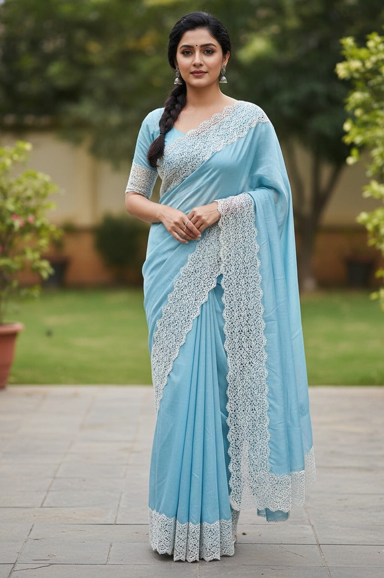 White floral cutwork lace fabric suitable for dresses and overlays.