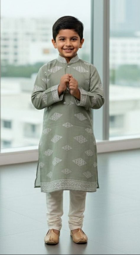 Kids ethnic wear fabric — pista green mirror work material with geometric white embroidery, soft and skin-friendly.
