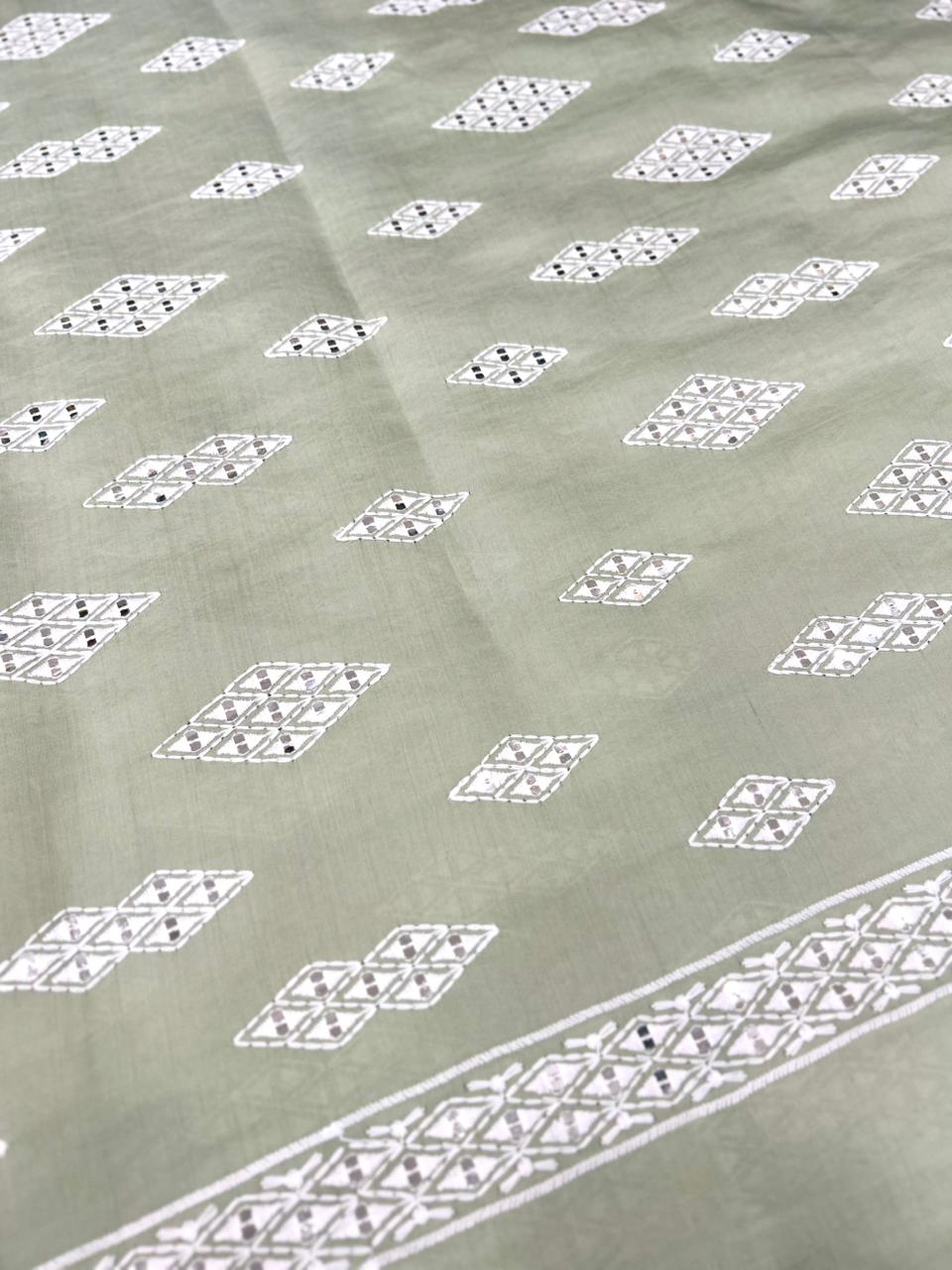Premium pista green Roman silk fabric for men with detailed white mirror work embroidery — ideal for wedding outfits.
