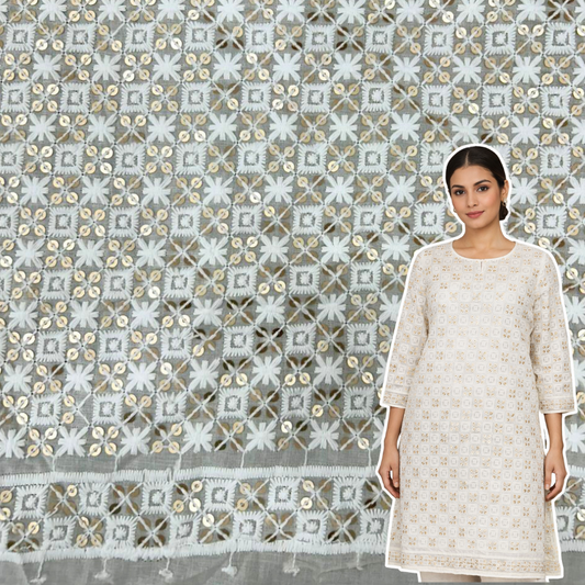 Textured fabric with geometric pattern and sequins on a gray background.