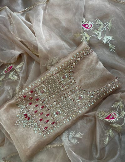 Beige unstitched kurta fabric has pearl and stone embroidery. It comes with a sheer embroidered dupatta. This outfit is perfect for festive and wedding wear.