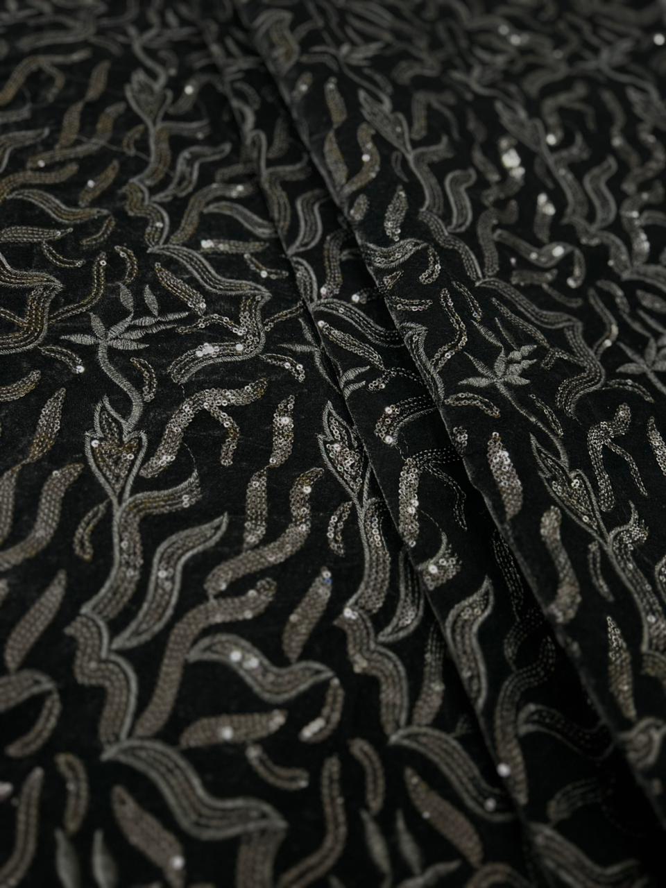 Premium black velvet fabric with intricate silver embroidery and wavy designer pattern.