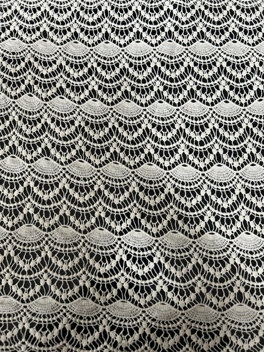 High-quality wave-design cutwork lace fabric with detailed scallop motifs — perfect for tunics, tops and resort fashion.