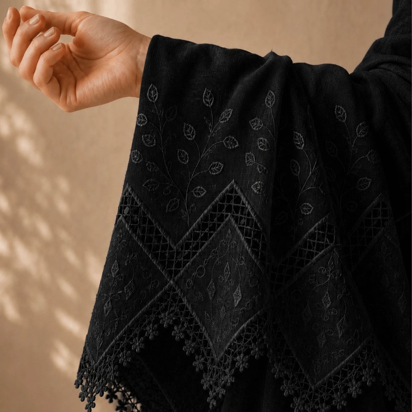 Premium black applique embroidery fabric with elegant cutwork border and floral embroidery.