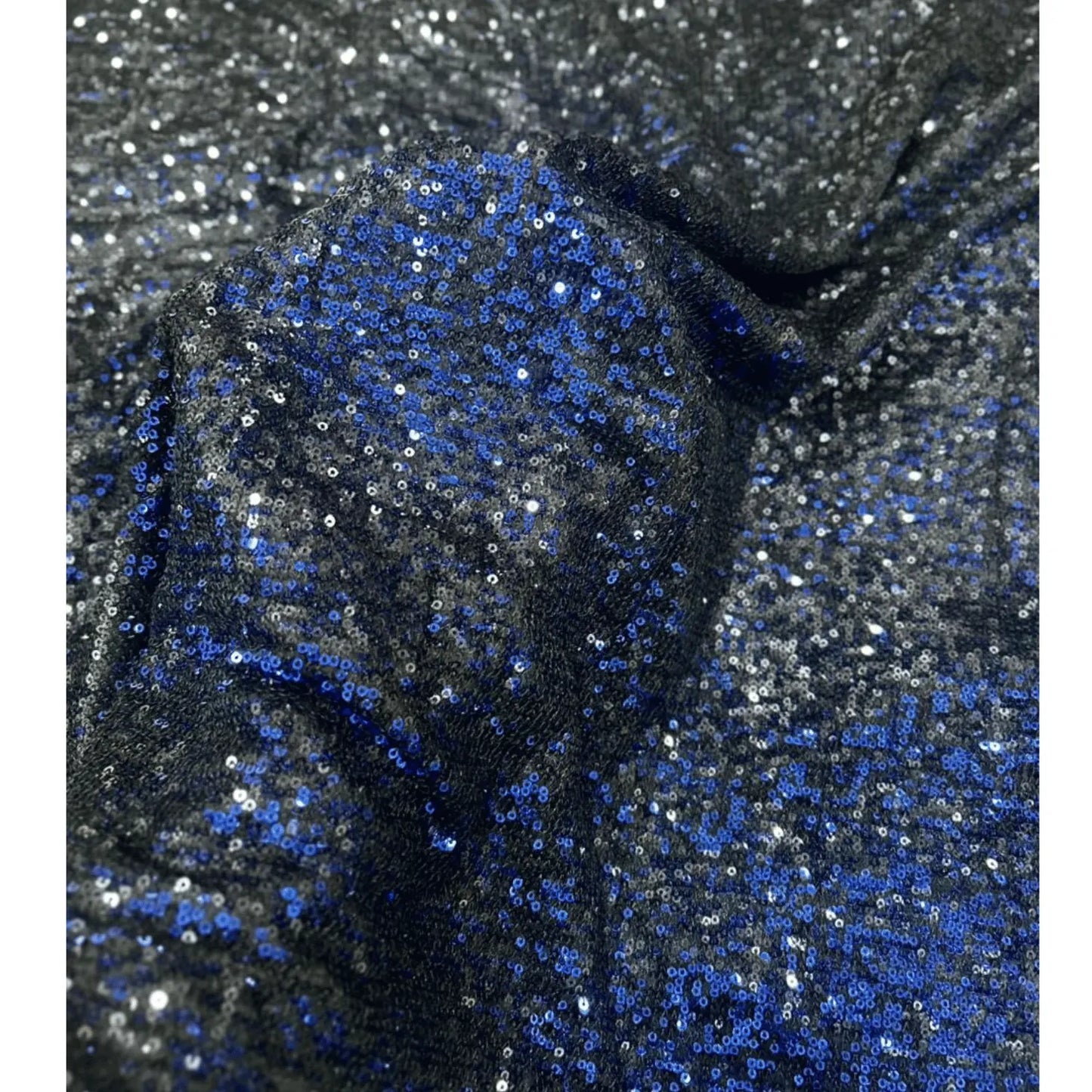 Close-up of premium black blue dual tone sequins net fabric featuring dense blue and silver sequin embroidery on a soft net base, showcasing its luxurious shimmer, rich texture, and elegant drape for bridal lehengas, gowns, sarees, cocktail dresses, and festive designer wear.