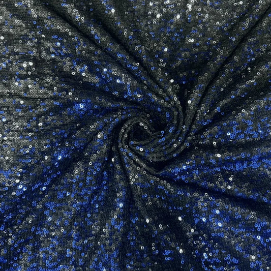 Premium black blue dual tone sequins net fabric arranged in a spiral drape, featuring heavy all-over blue and silver sequin embroidery on a soft net base with a luxurious shimmer finish, ideal for bridal lehengas, gowns, sarees, cocktail dresses and festive party wear.