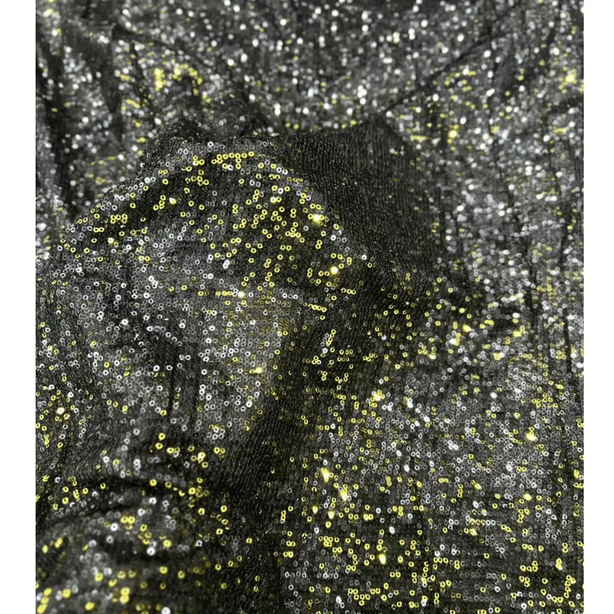 Close-up of premium black gold dual tone sequin net fabric featuring dense all-over gold and silver sequins on a soft net base, highlighting its luxurious sparkle, rich texture and designer finish for bridal, party wear and festive outfits.