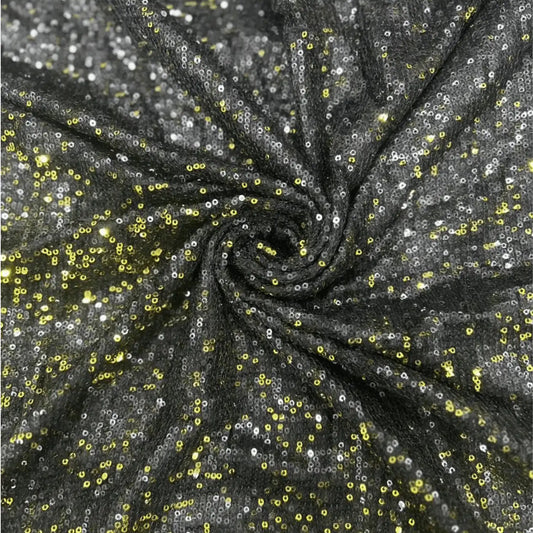 Premium black gold dual tone sequin net fabric arranged in a spiral drape, featuring heavy all-over gold and silver sequin embroidery on a soft net base with a luxurious shimmer, perfect for bridal lehengas, gowns, sarees, cocktail dresses and party wear.