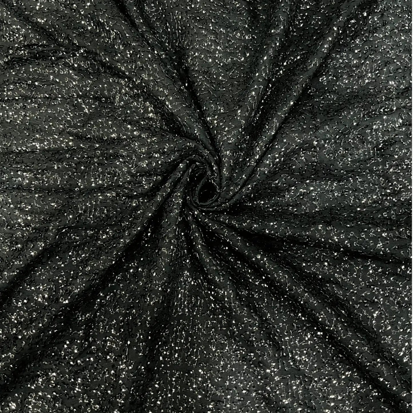 Luxury black shimmer khichdi georgette fabric featuring an all-over sparkling design on premium georgette. Perfect for designer gowns, ethnic wear, cocktail dresses, bridal wear and fashion garments.