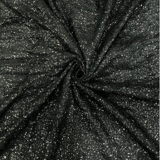 Luxury black shimmer khichdi georgette fabric featuring an all-over sparkling design on premium georgette. Perfect for designer gowns, ethnic wear, cocktail dresses, bridal wear and fashion garments.