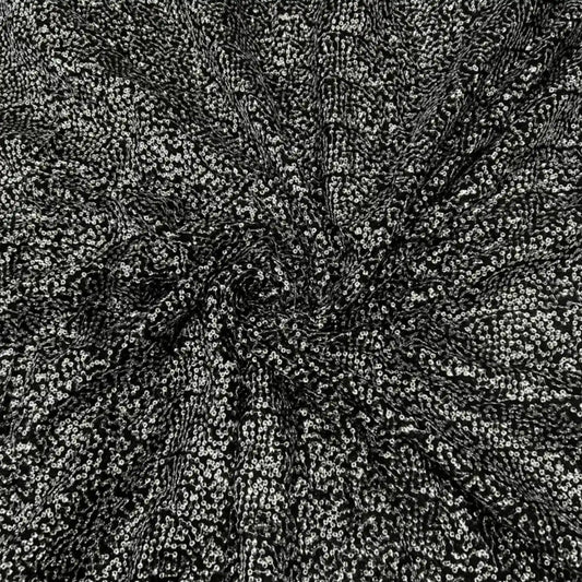 Premium black Kichdi net fabric arranged in a spiral drape, featuring heavy all-over textured Kichdi embroidery on a soft net base with a rich designer shimmer finish, ideal for bridal lehengas, gowns, sarees, blouses and luxury party wear.