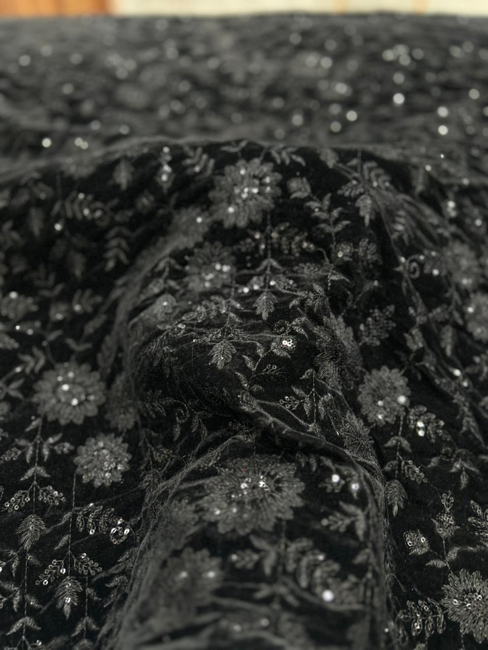 High quality black velvet fabric texture with floral work, soft premium finish suitable for ethnic and Indo-Western tailoring