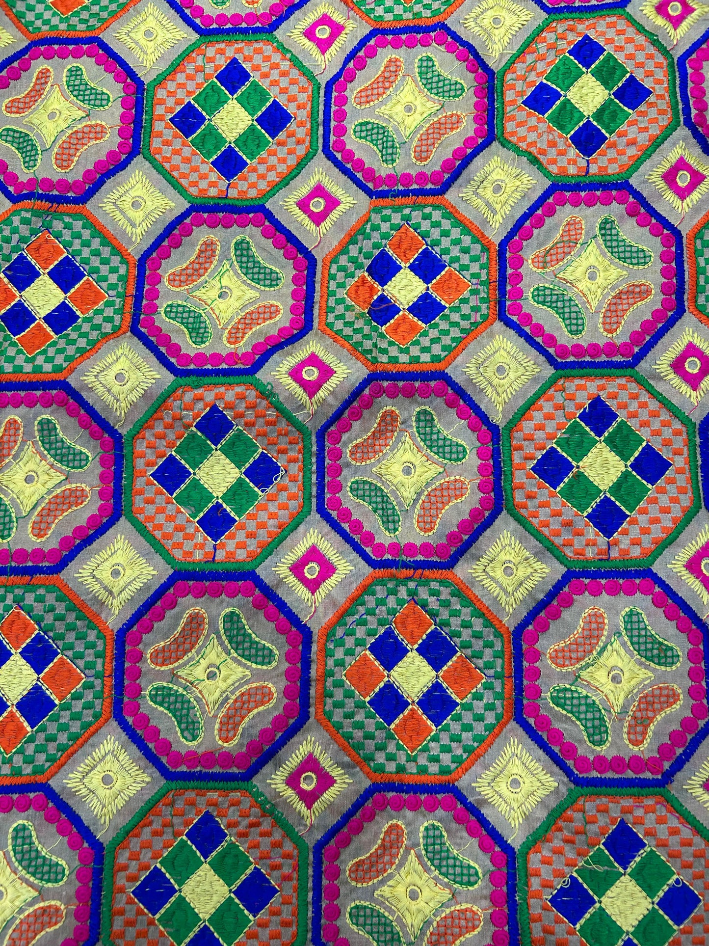 Multicolor hexagon pattern brocade silk fabric with traditional woven design.