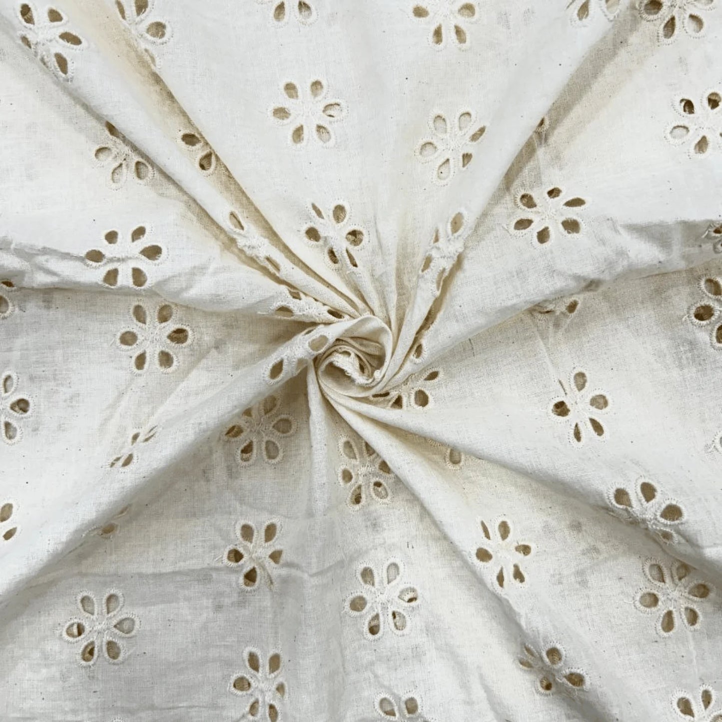 Dyeable white Hakoba Schiffli cotton fabric with floral eyelet embroidery, soft breathable 100% cotton, 44-inch width, ideal for kurtis, dresses, tops, kidswear and DIY sewing projects.