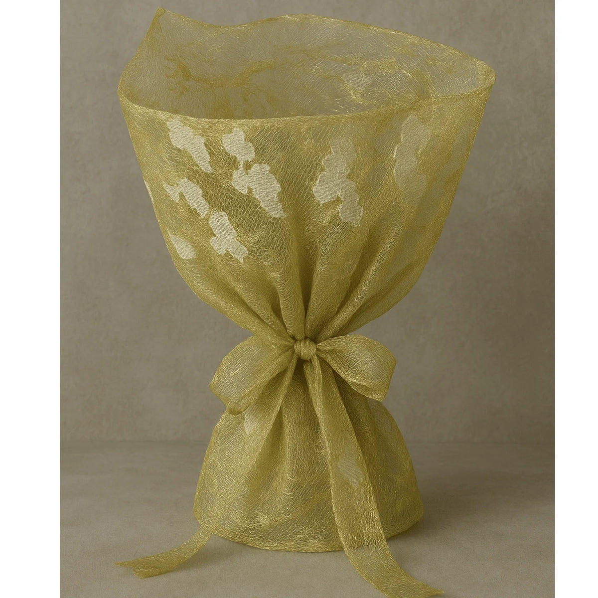 Premium golden embroidered decoration net fabric styled to showcase its soft drape, elegant thread work and shimmering finish, ideal for festive fashion and decorative applications.