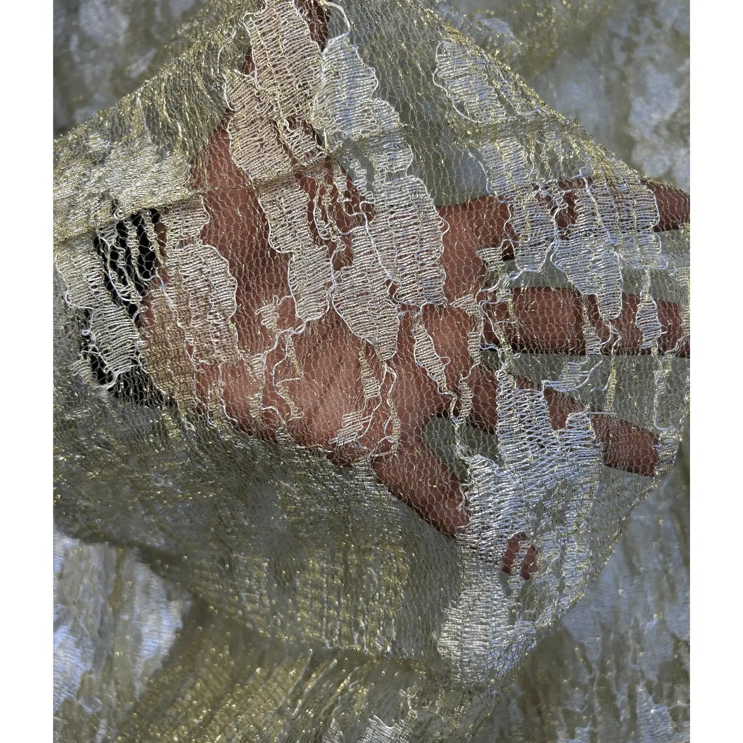 Close-up of premium golden embroidered decoration net fabric showcasing intricate thread work, sheer texture and elegant metallic finish for festive and designer wear.