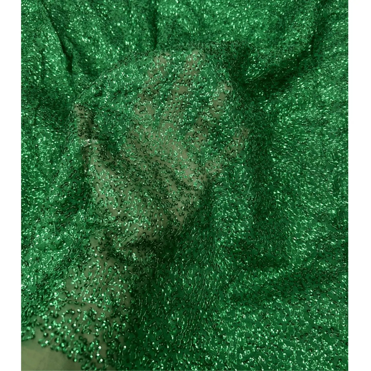 Luxury emerald green Kichdi net fabric with heavy all-over textured embroidery, displayed in a spiral fold to highlight its premium shimmer, elegant drape and designer finish for festive, bridal and party wear outfits.